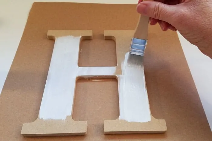 Initial letter is painted white for monogram door hanger.