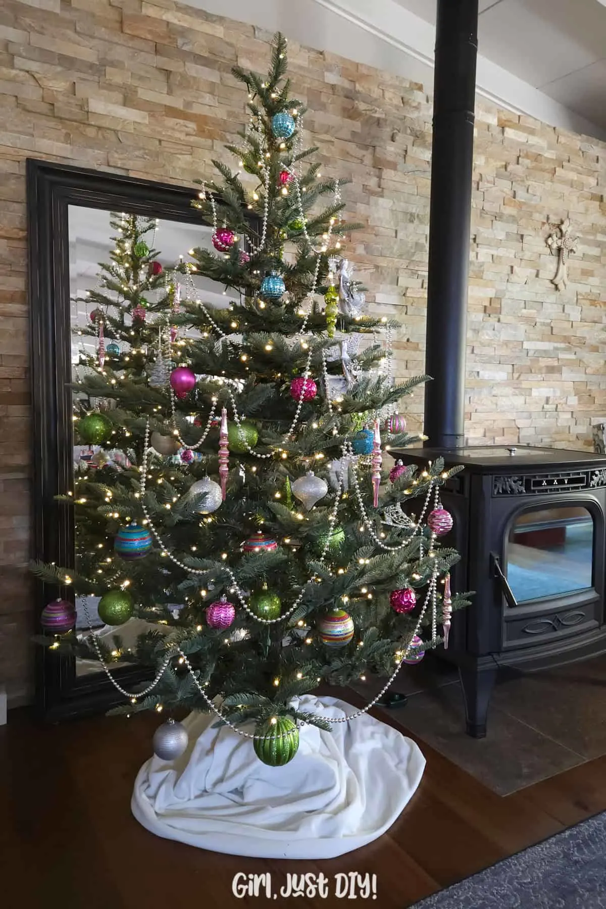 Six foot decorated christmas tree in front of a mirror,